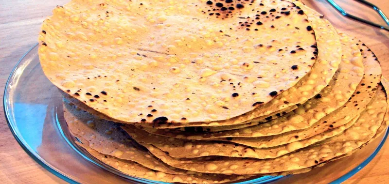 Representative image: a stack of roasted papads on a glass plate