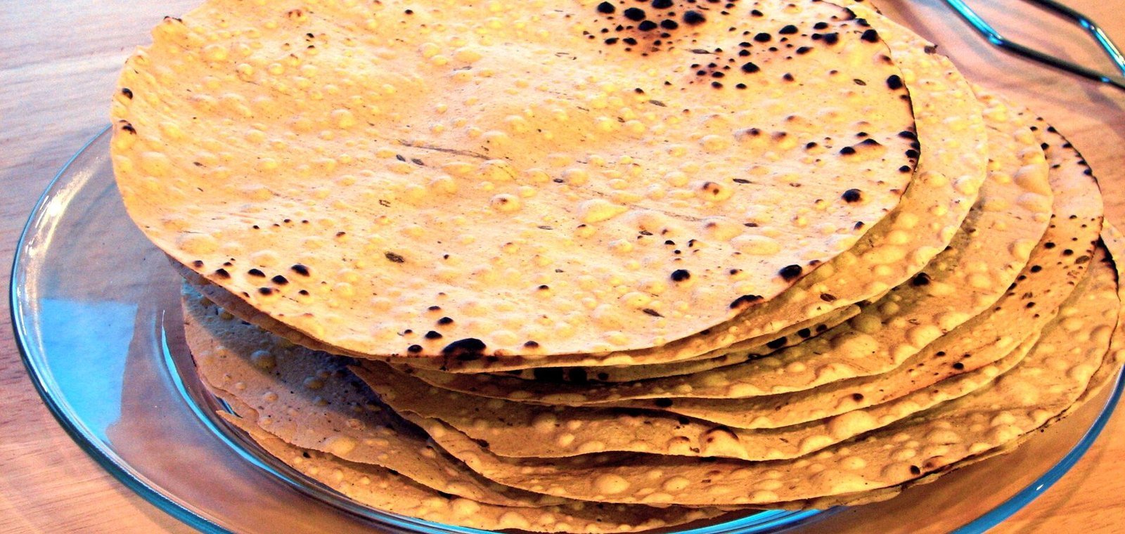Representative image: a stack of roasted papads on a glass plate